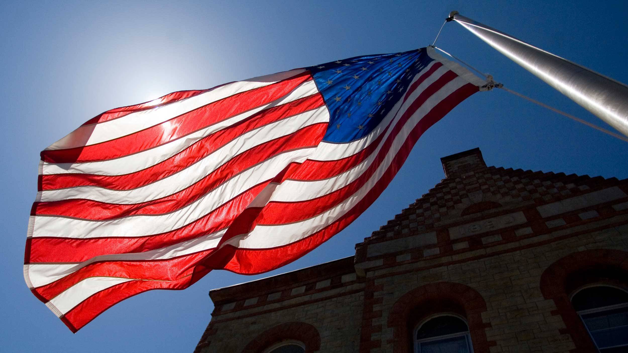 American flag flies outside out James B. Colgate Hall