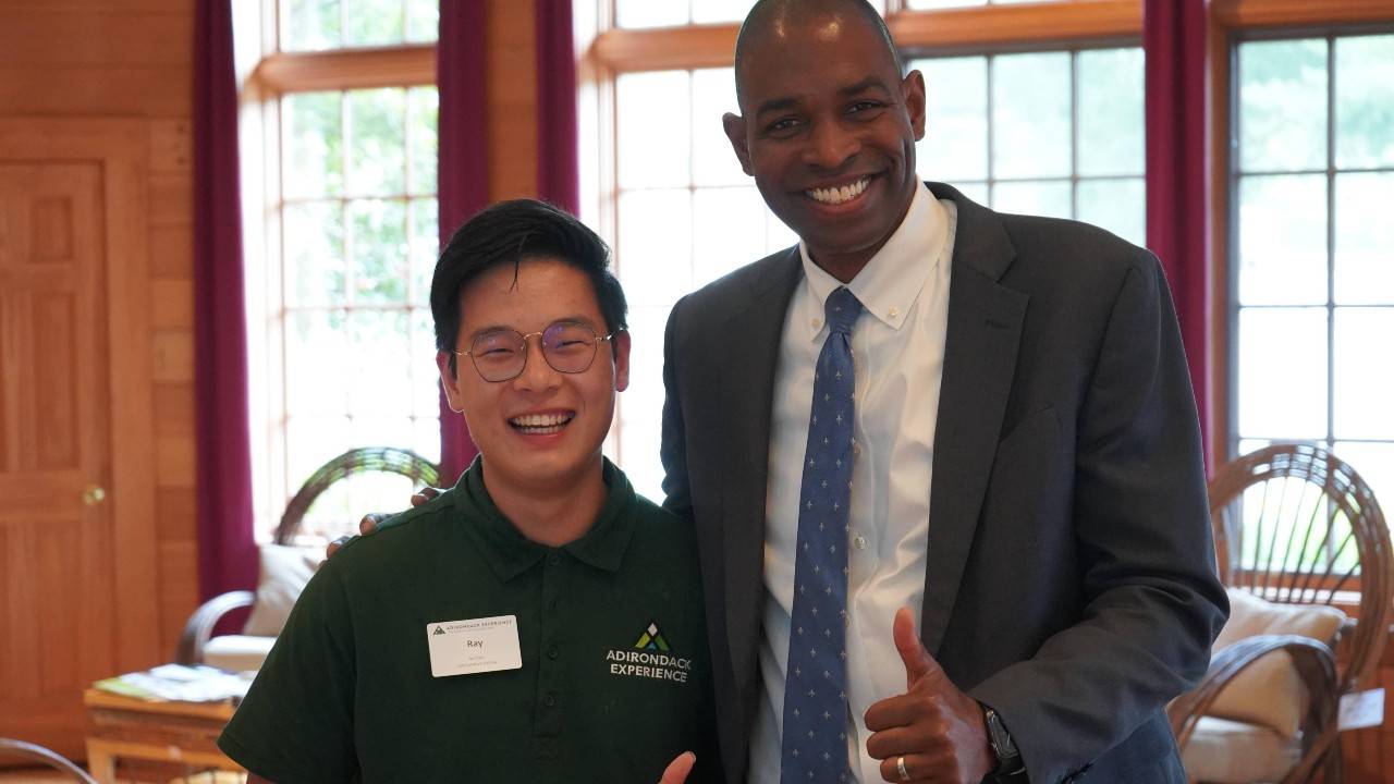 Museum ambassador stands with patron