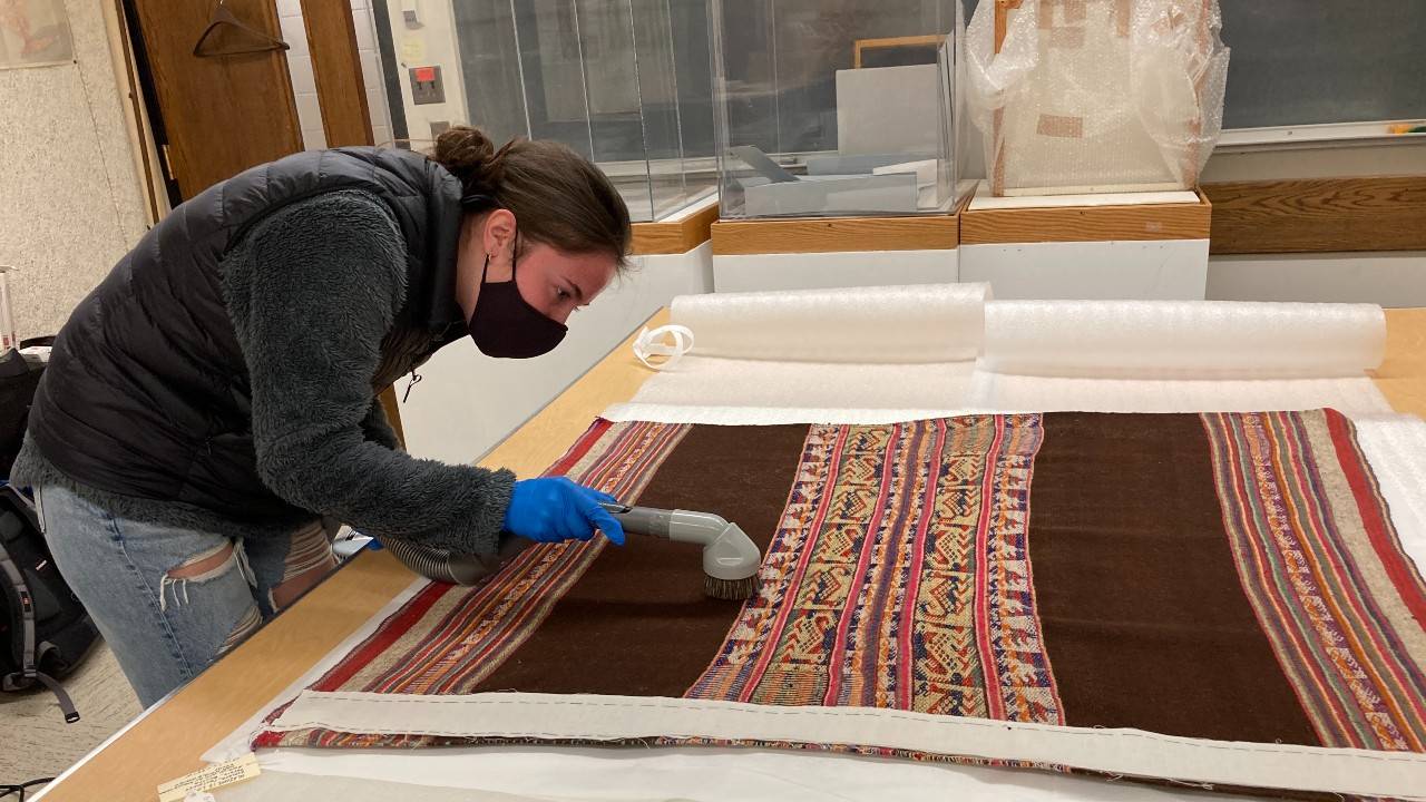 Student vacuums textile