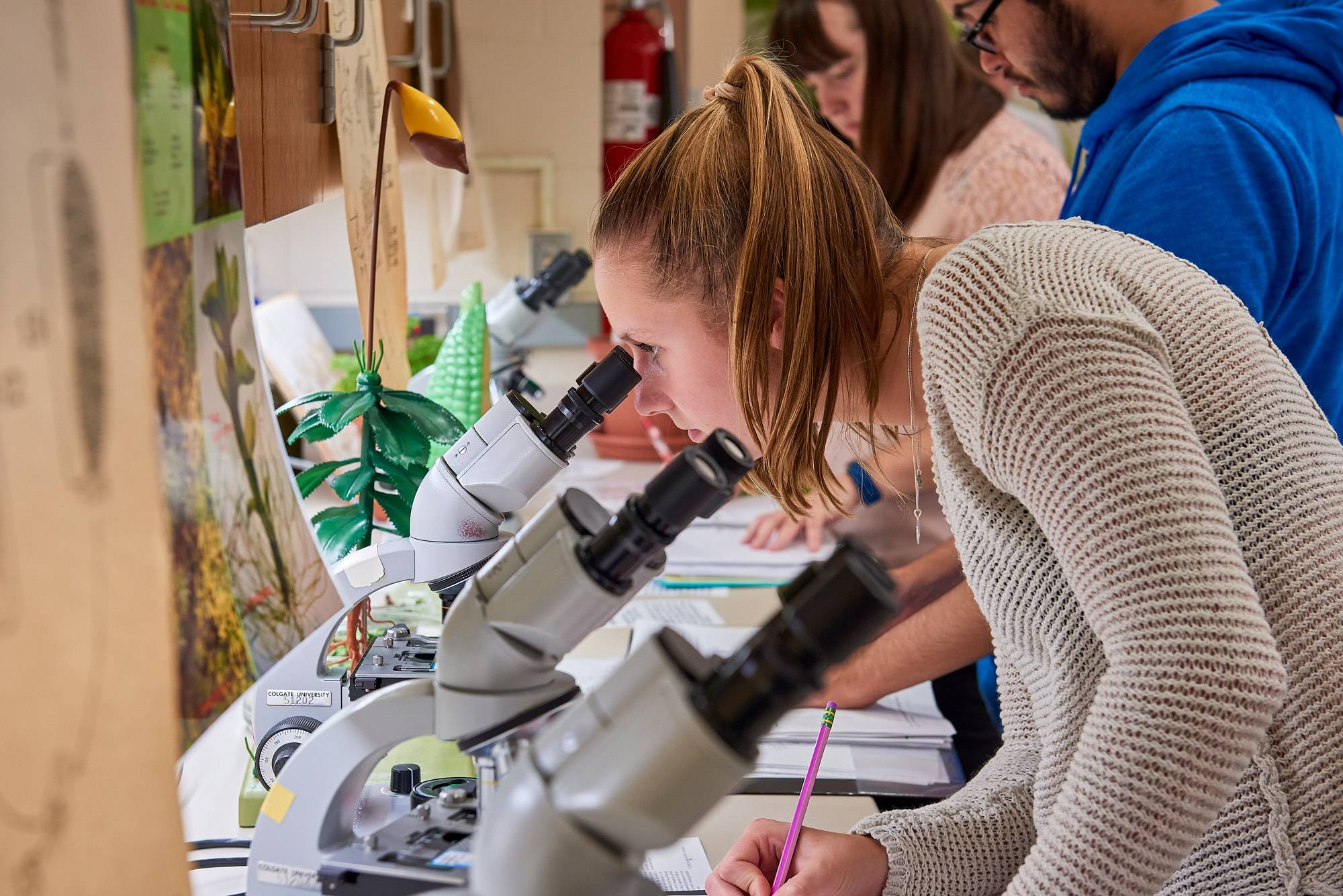 Student in classroom at microscope