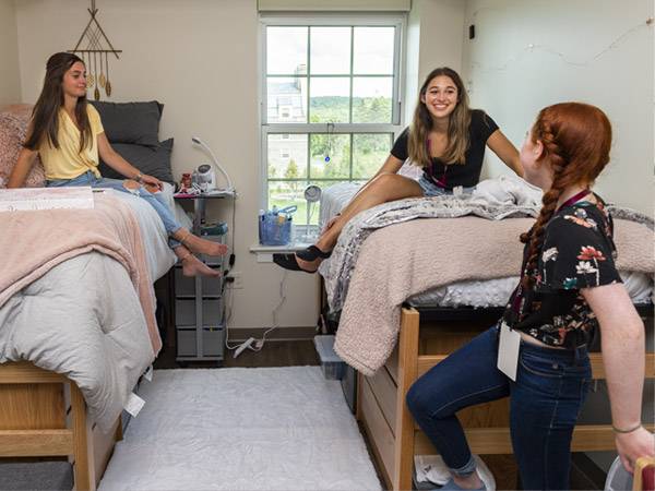 Students in residence hall room.