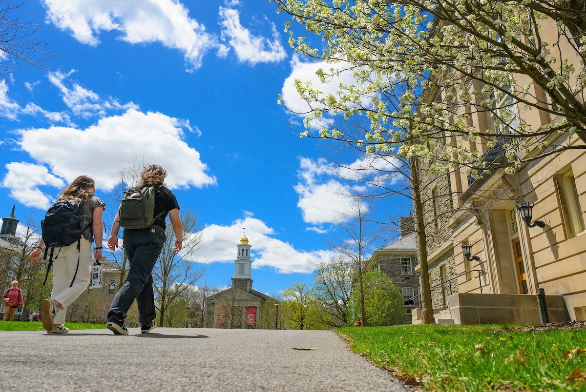 Two students walk through the Academic Quad