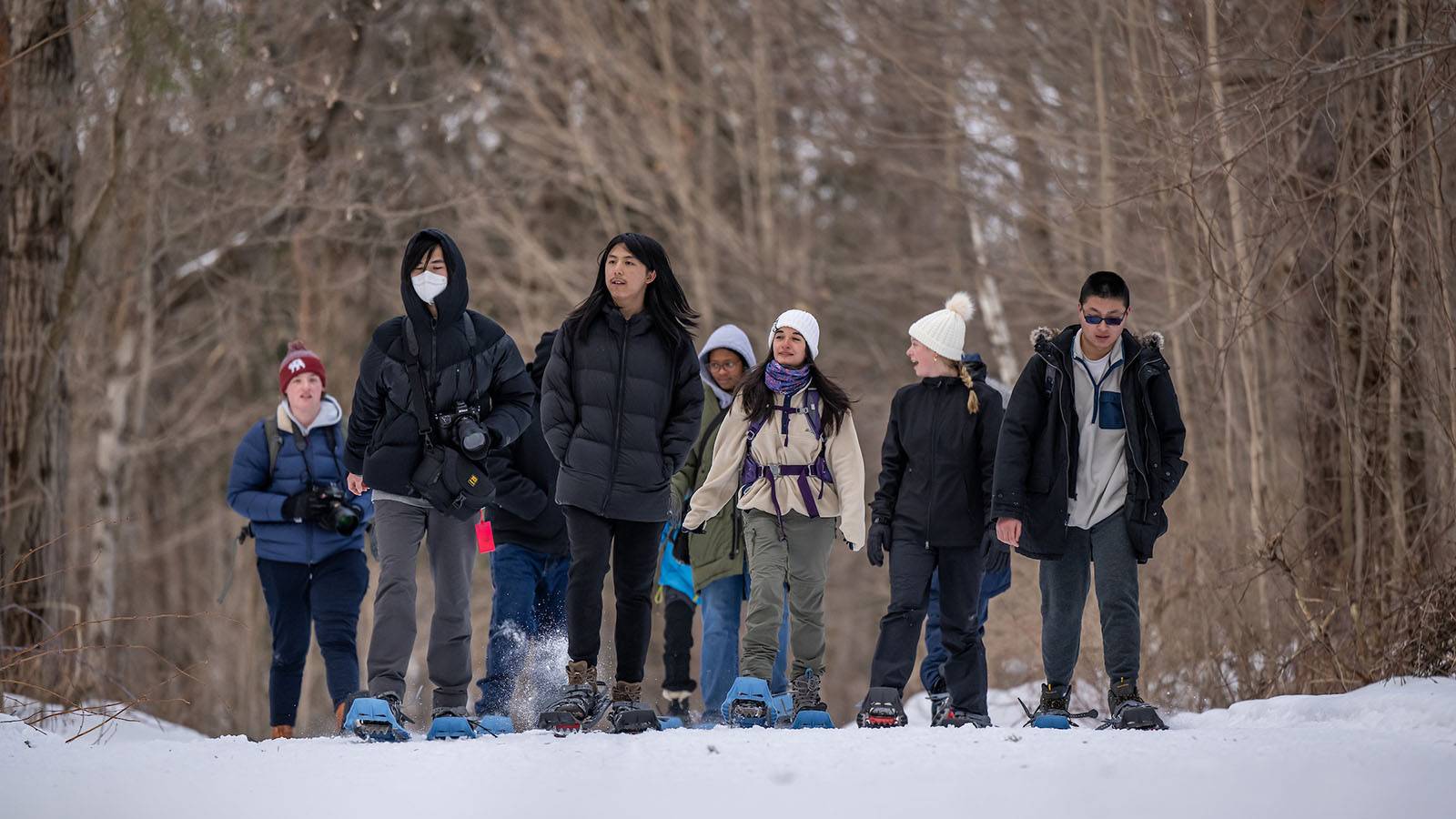 Students snowshoeing on campus