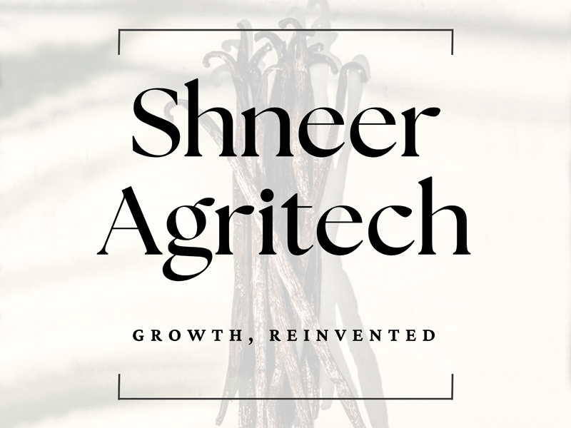 A faded image of vanilla beans with the words Shneer Agritech superimposed over it.