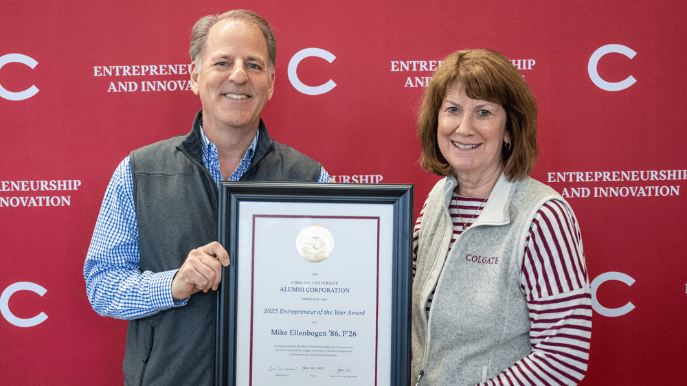 Entrepreneur of the Year for 2025 Michael Ellenbogen holding an award given to him by Lauri Curtis Hadobas.