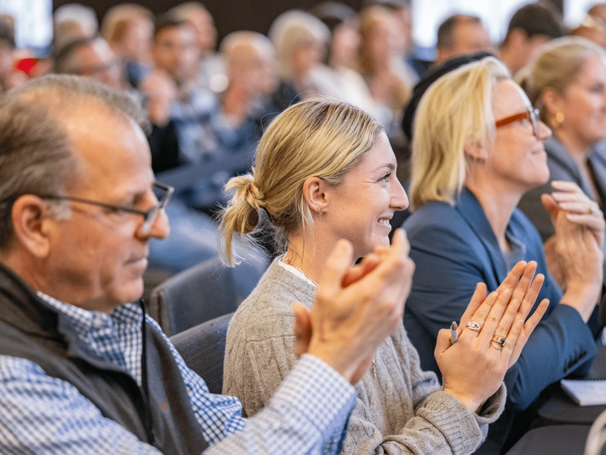 Seated judges during the Entrepreneur Showcase clap at the conclusion of a venture's pitch.