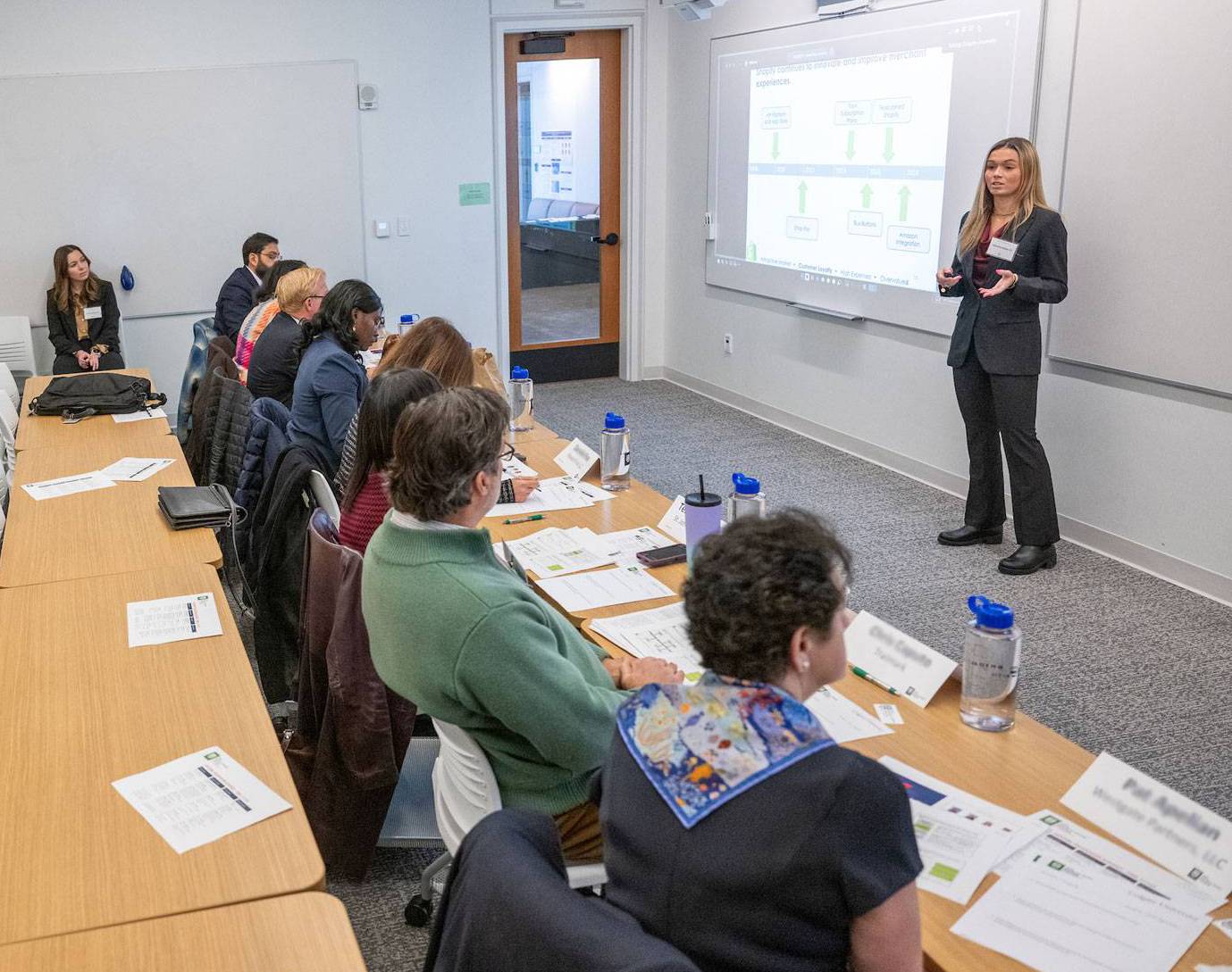 Student presents to alumni during Tuck Business Bridge at Colgate