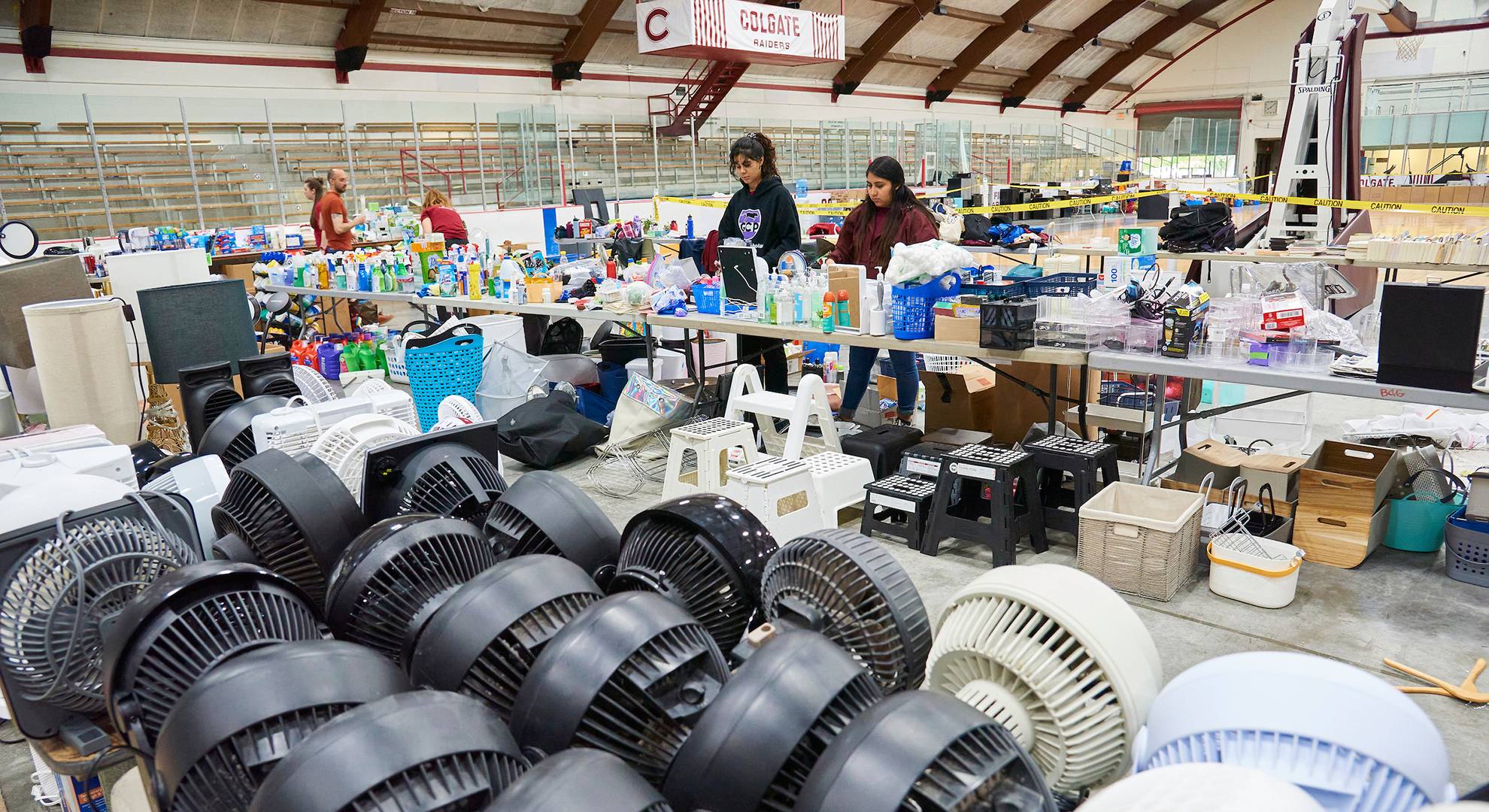Students inside a warehouse sort bikes by size and add air to their tires.
