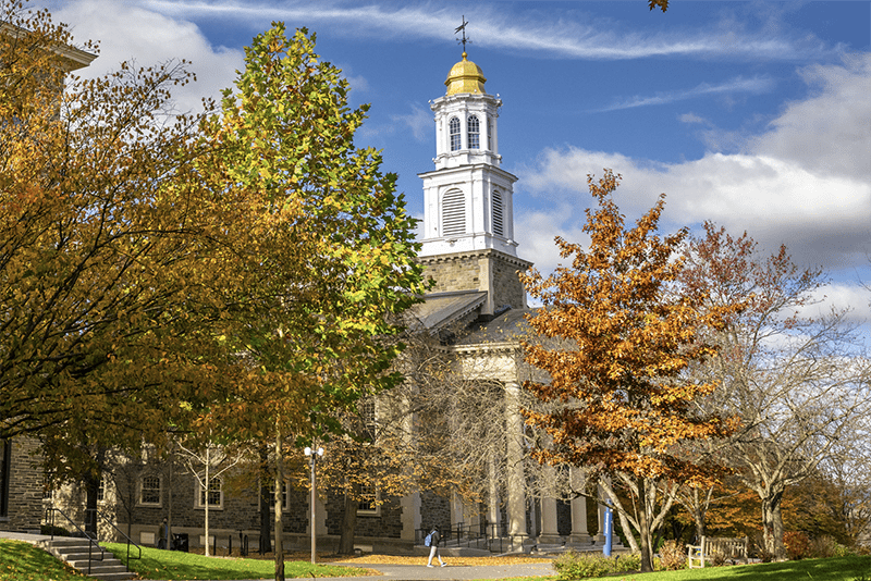 A student walks past the Colgate Memorial Chapel in the fall