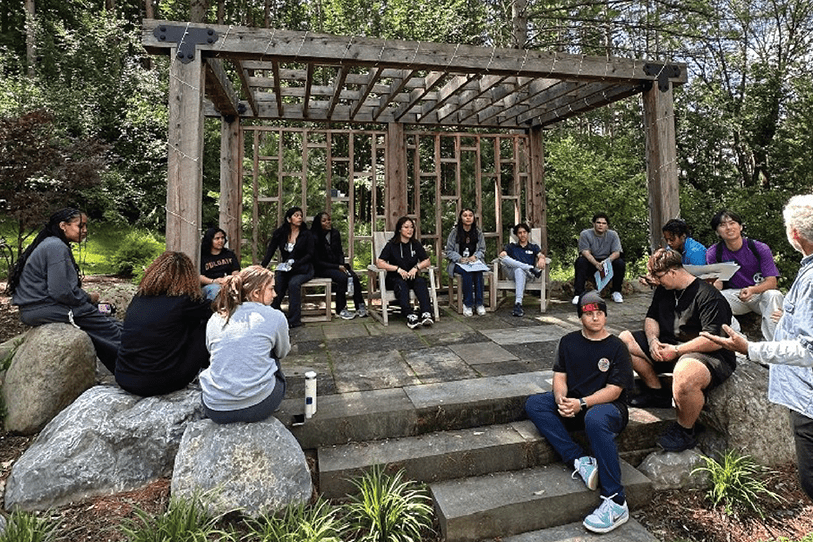 Students sit outside near the zen garden