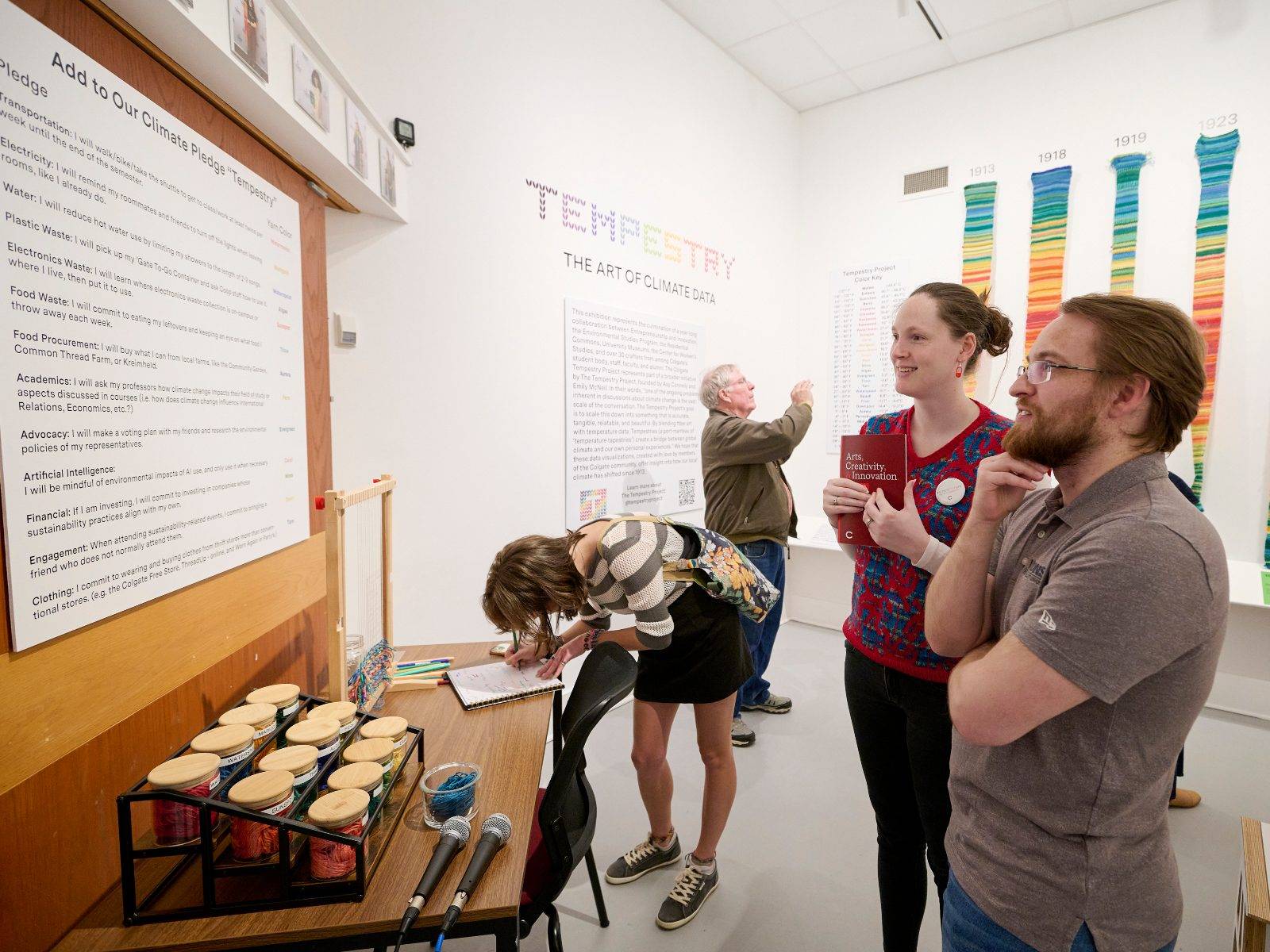 Tempestry crafters and visitors check out the interactive Climate Pledge Tempestry at the opening reception for “Tempestry: The Art of Climate Data” at the Longyear Museum of Anthropology, April 10. 