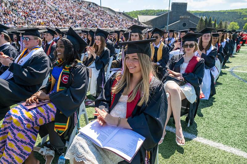 Students sit in chairs during Commencement