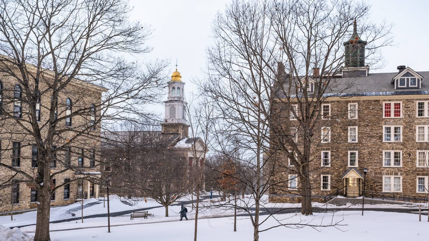 Student walking on the quad during a snowy winter.