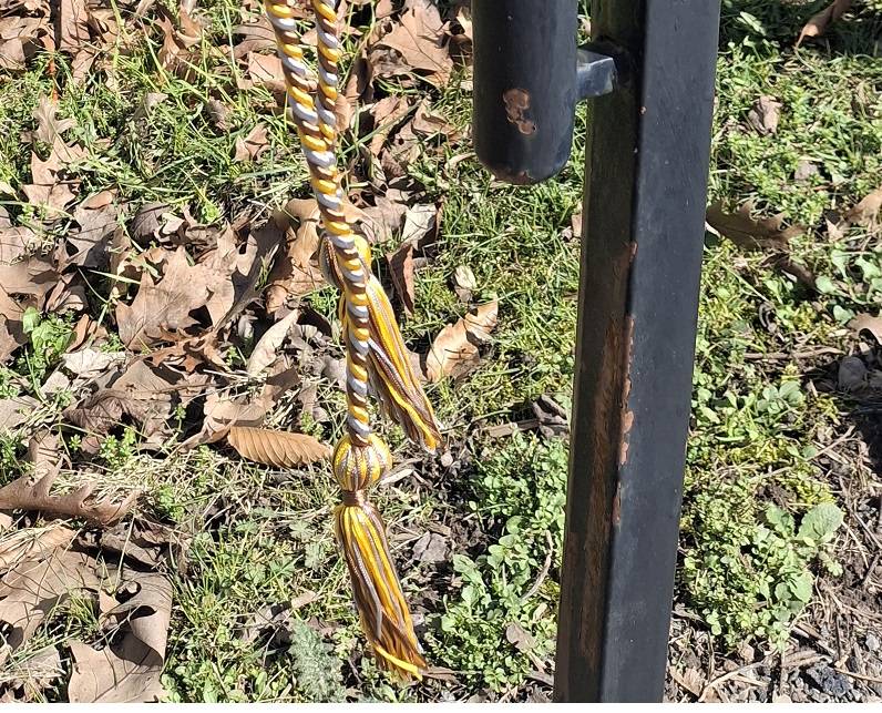 Honors cord hanging from railing.