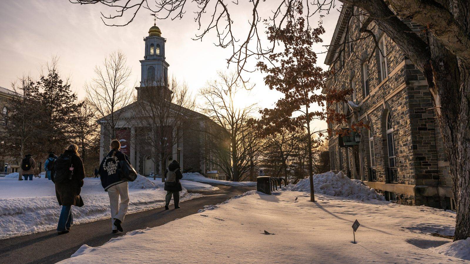 Students walk on the snowy quad near the Colgate Chapel.