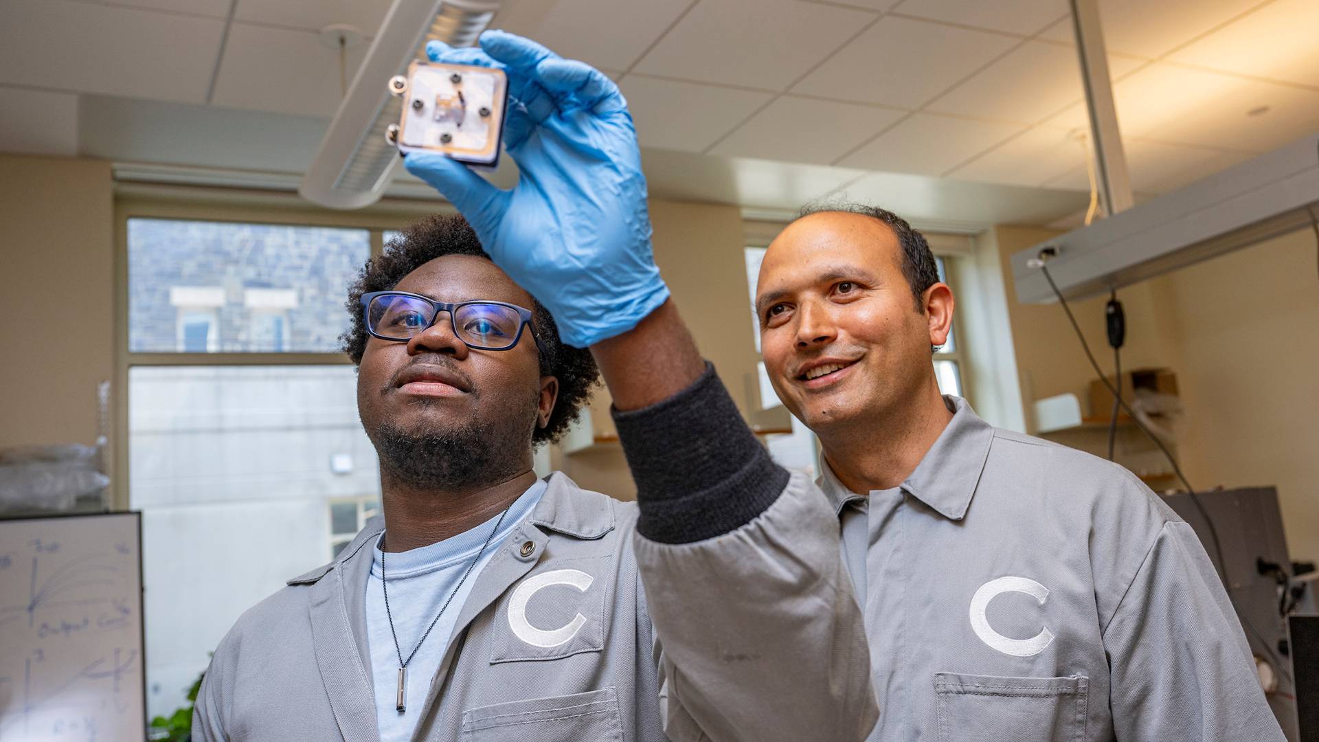 Nathan Walsh ’28 and Assistant Professor of Physics Ramesh Adhikari work on a small battery that utilizes a leaf as a critical component June 11, 2026. The actual piece of leaf that the battery utilizes is inside of the battery. 